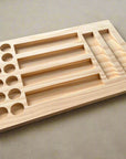 Australian made pine wood storage tray with various sized holes arranged in rows for sorting and organizing objects.